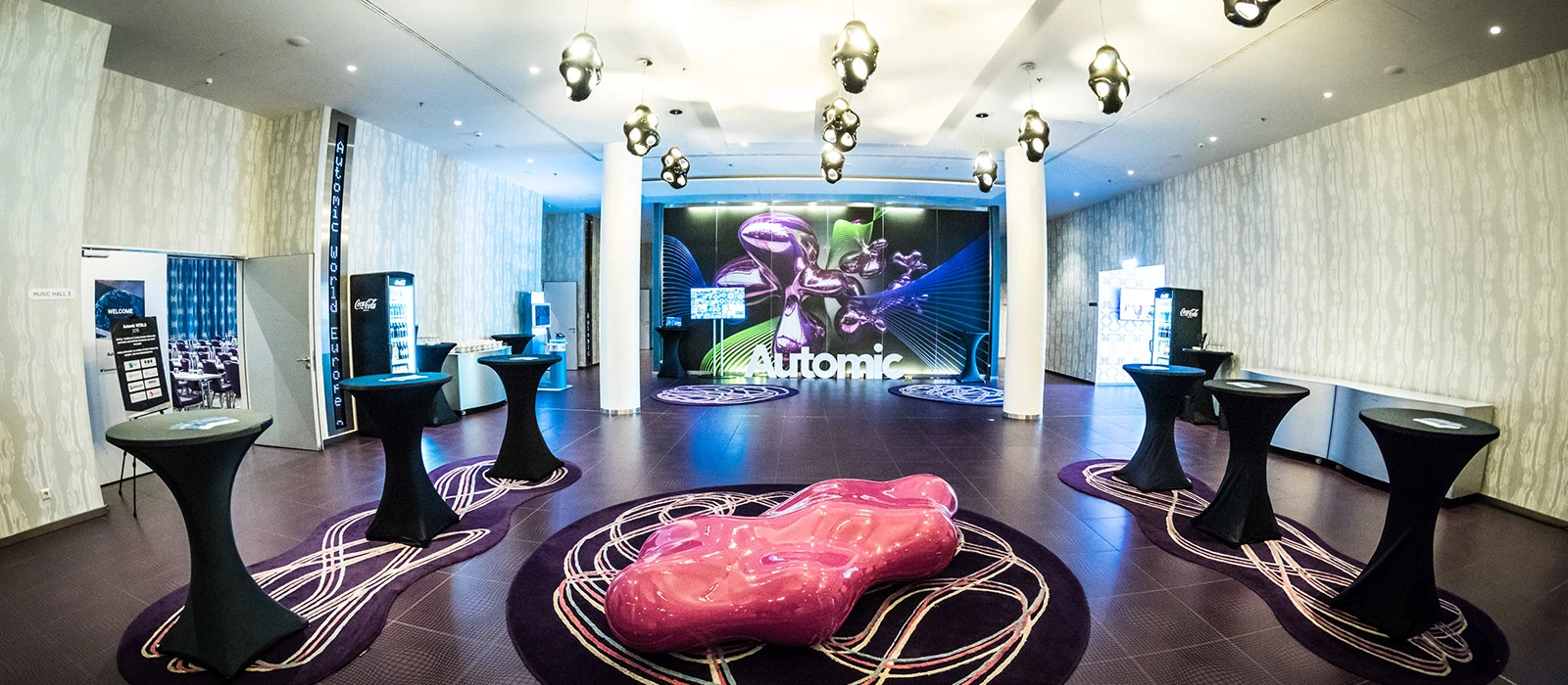 Gebrandeter Eventraum für Automic World Europe mit Screens und Loungemöbeln